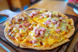 Fresh pizza with ham, cheese on wooden table closeup