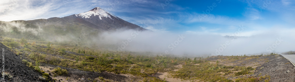 Amazing panoramic view of Osorno Volcano volcanic cone summit. Awe volcanic scenery on a remote location on a misty day with a moody atmosphere just an amazing Patagonia scenic landscape