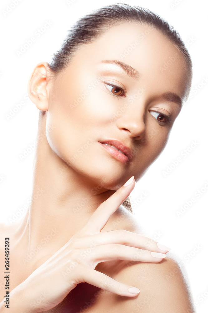 Beauty portrait of young woman with perfect skin. Hand finger near lips, natural nude make-up. Isolated. White background. Facial treatment female health concept Beauty portrait of young woman with perfect skin. Hand finger near lips, natural nude make-up. Isolated. White background. Facial treatment female health concept