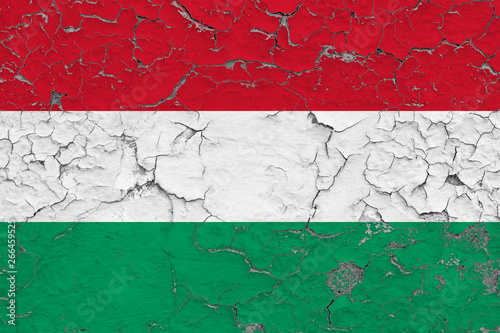 Flag of Hungary painted on cracked dirty wall. National pattern on vintage style surface.
