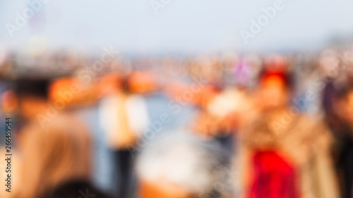 A defocused scene of a group of people enjoying a beautiful morning on the bank of the river "The Ganges" at Allahabad (India) Kumbh 2019.