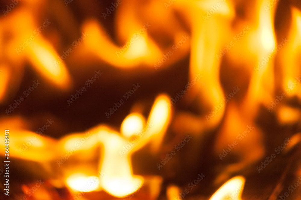 Artistic out of focus view of Fire red hot flames from burning wood and coal.