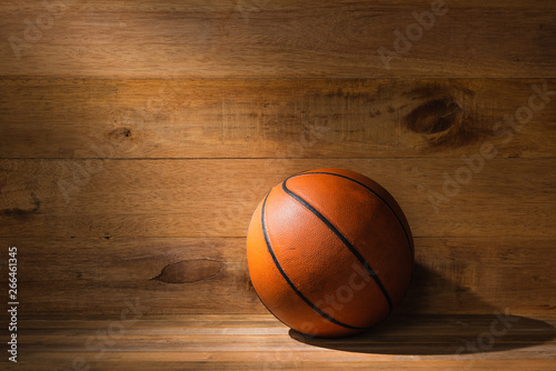 ray of light falling on old basketball on wooden floor