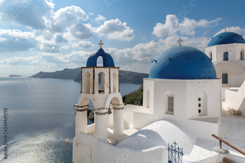 Santorini, Greece. Greek orthodox church with blue domes and sea in Oia town, Santorini island, Greece.