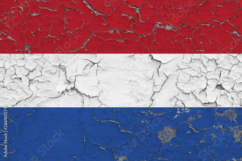 Flag of Netherlands painted on cracked dirty wall. National pattern on vintage style surface.