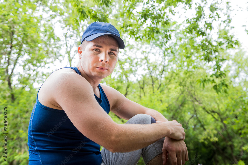 Portrait of attractive fitness man in the park Portrait of attractive fitness man in the park