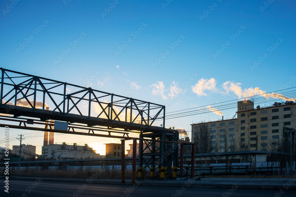 Factory steam in the sunset sun