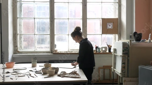 stylish woman ceramist draws a mock designer ceramics photo