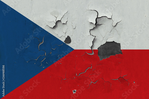Close up grungy, damaged and weathered Czech Republic flag on wall peeling off paint to see inside surface.