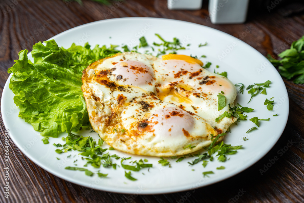Flat lay of tasty breakfast over grey concrete table background. Fried eggs, micro greens, fresh tomatoes in plate, top view. Clean eating, dieting, vegetarian food - Image Flat lay of tasty breakfast over grey concrete table background. Fried eggs, micro greens, fresh tomatoes in plate, top view. Clean eating, dieting, vegetarian food - Image