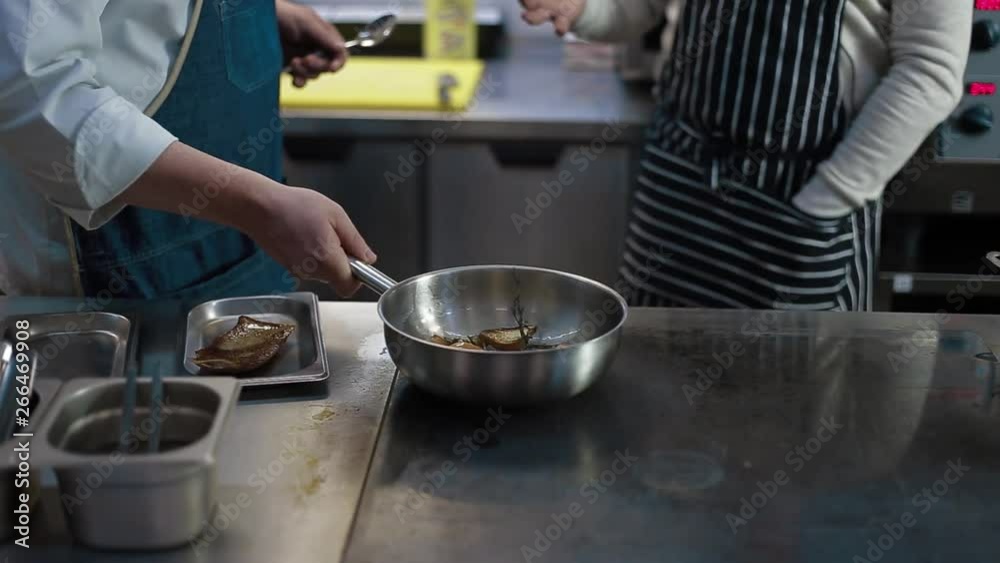 The cook prepares a duck with rice in the kitchen of the restaurant. Close-up without a face. Hands cook preparing duck with rice The cook prepares a duck with rice in the kitchen of the restaurant. Close-up without a face. Hands cook preparing duck with rice