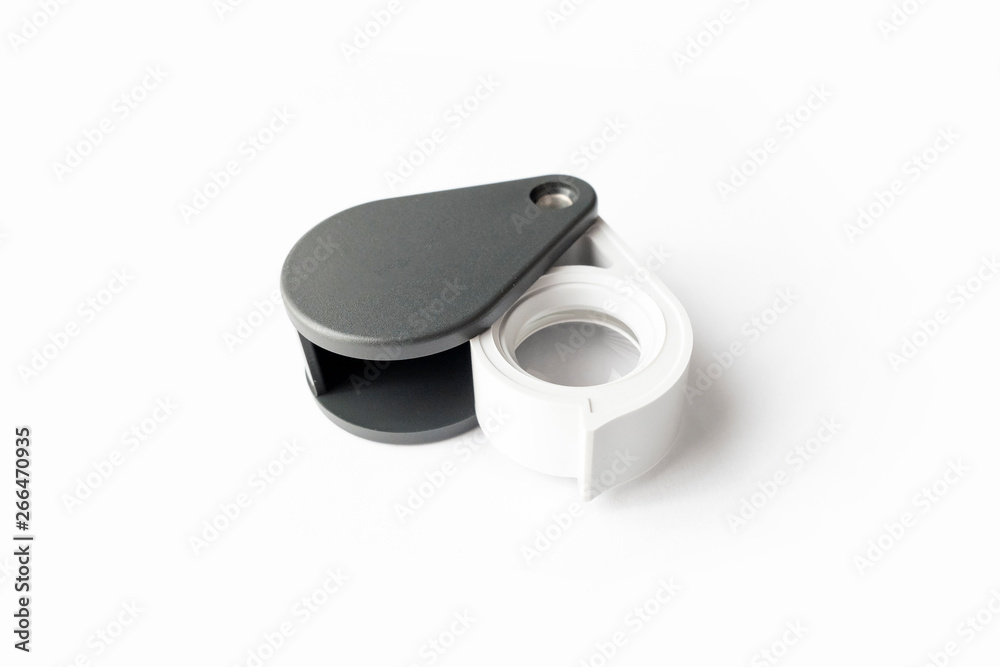 Magnifying glass for diamonds or see the amulet Isolated on a White Background. Magnifying glass for diamonds or see the amulet Isolated on a White Background.