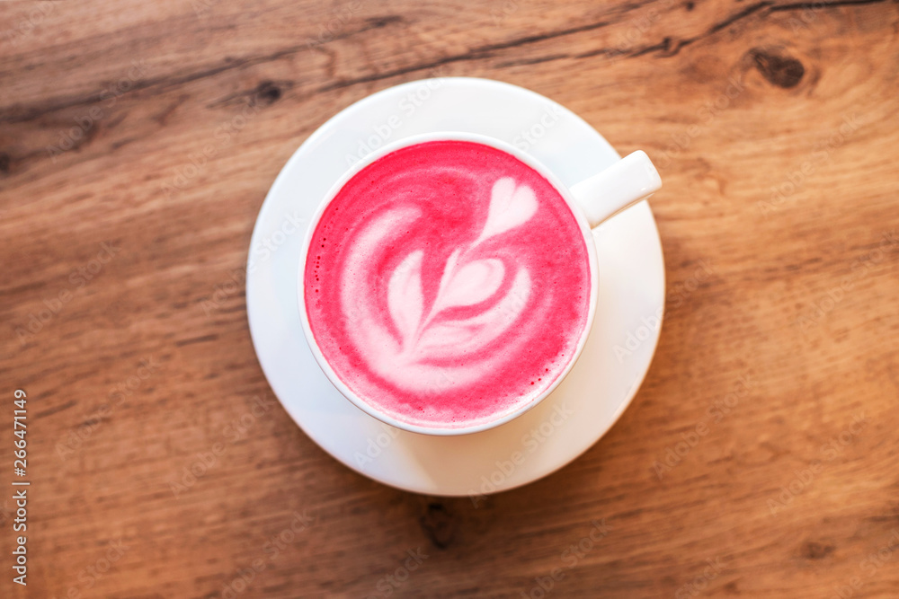 Cup of trendy beetroot latte on table. Cup of trendy beetroot latte on table.