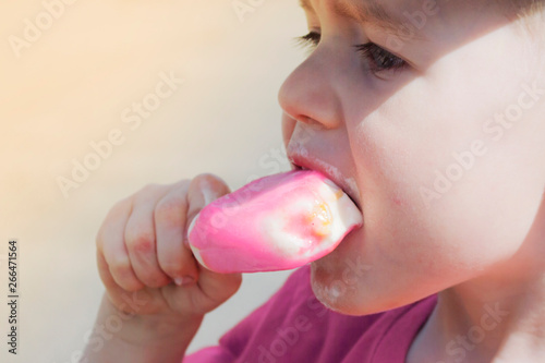 Wallpaper Mural portrait of a child who eat ice cream on a warm summer day. boy in a baseball cap and the sun is shining, close-up face Torontodigital.ca