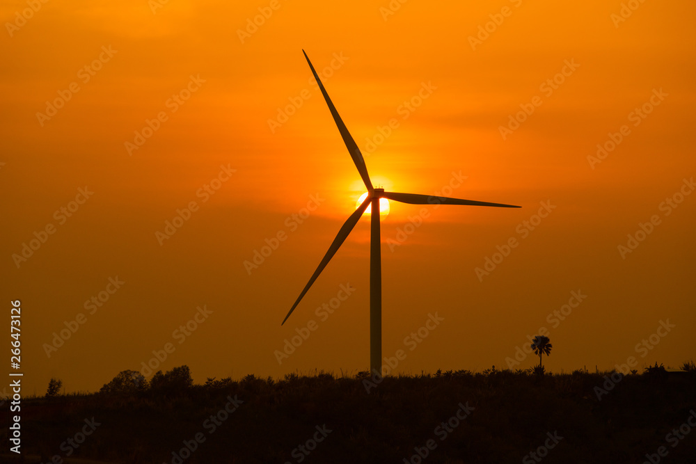 Silhouette of Wind turbine during sunrise or sunset,wind turbines silhouette on mountain,Beautiful sunsets with wind power generators Silhouette of Wind turbine during sunrise or sunset,wind turbines silhouette on mountain,Beautiful sunsets with wind power generators