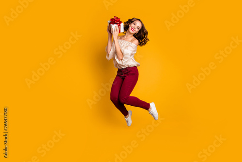 Full length body size view portrait of nice attractive pretty glad cheerful cheery wavy-haired lady holding in hands box event occasion isolated over bright vivid shine yellow background