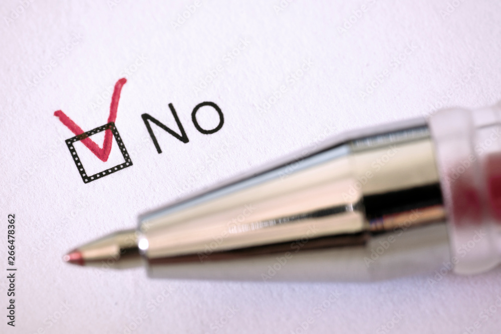 Questionnaire. Red pen and the inscription NO with check mark on the white paper Questionnaire. Red pen and the inscription NO with check mark on the white paper
