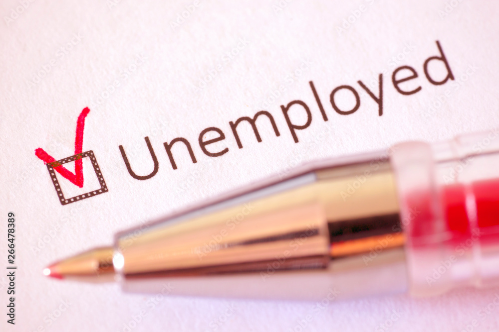 Questionnaire. Red pen and the inscription UNEMPLOYED with check mark on the white paper Questionnaire. Red pen and the inscription UNEMPLOYED with check mark on the white paper