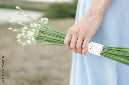 Beautiful bride in blue dress with simple elegant bouquet 