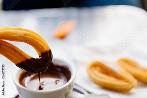 Fotografie Delicious Spanish dessert churros with chocolate sauce