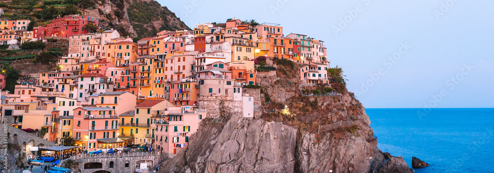 Stunning view of the beautiful and cozy village of Manarola in the Cinque Terre Reserve at sunset. Liguria region of Italy.