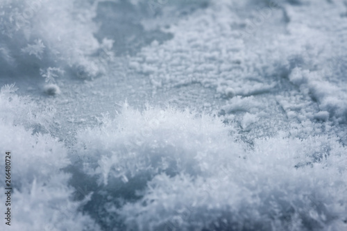 Frosty pattern on ice, winter season background, macro shot.
