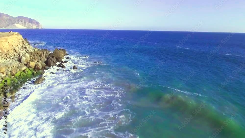 Aerial, drone shot of Point Mugu, towards rock over ocean, on a sunny day, in Oxnard, California, USA Aerial, drone shot of Point Mugu, towards rock over ocean, on a sunny day, in Oxnard, California, USA