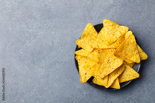 Nachos chips in bowl. Grey stone background. Copy space. Top view.