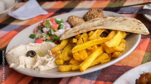 Closeup French fried with humus and pita plate