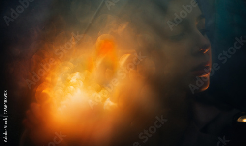 Portrait of a woman on the background of lights with multiple exposure.