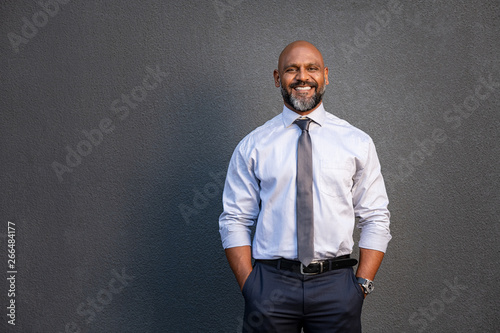 African american businessman smiling on grey