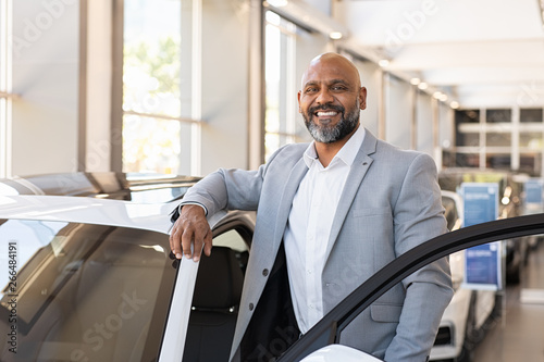 Photography Happy mature black man at car dealership