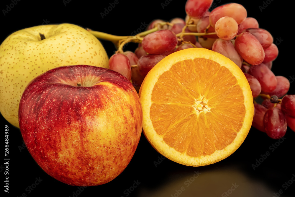 Orange, grapes, apple and pyrus pyriflora on a black background. Orange, grapes, apple and pyrus pyriflora on a black background.