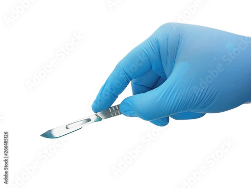 Hand of surgeon in blue medical glove holding a scalpel with blade isolated on white background with clipping path