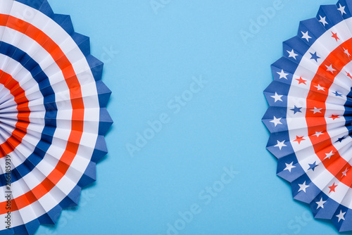 4th of July holiday banner design. USA theme paper fans on blue background flat lay. Independence Day lanterns template with copy space.