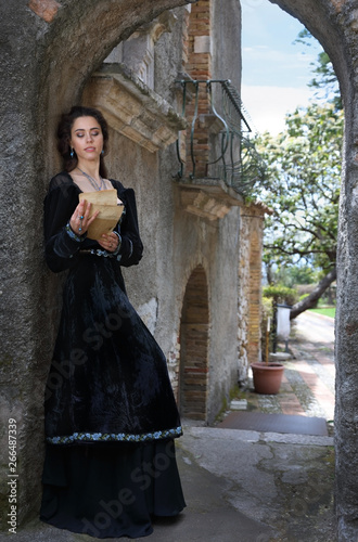 A beautiful young woman reading a letter