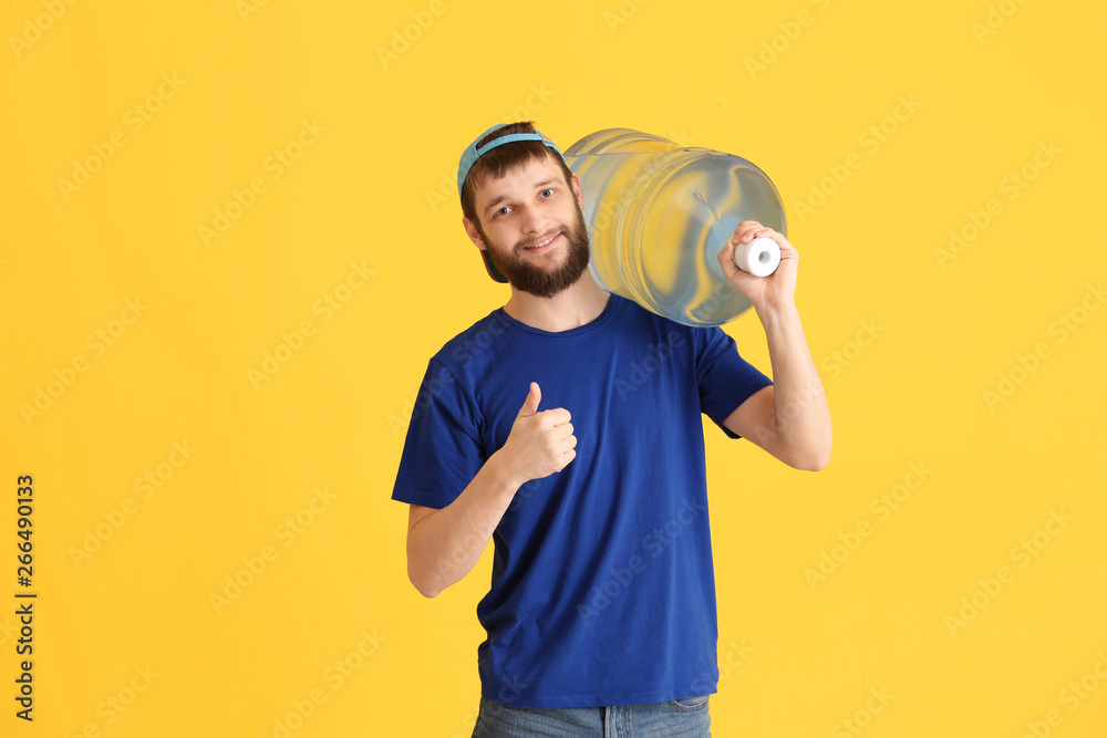 Delivery courier with bottle of water showing thumb-up gesture on color background Delivery courier with bottle of water showing thumb-up gesture on color background