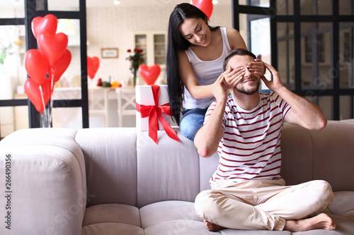 Young woman greeting her hu...