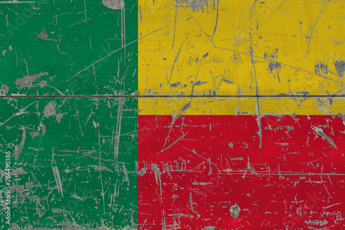 Grunge Benin flag on old scratched wooden surface. National vintage background. © sezerozger