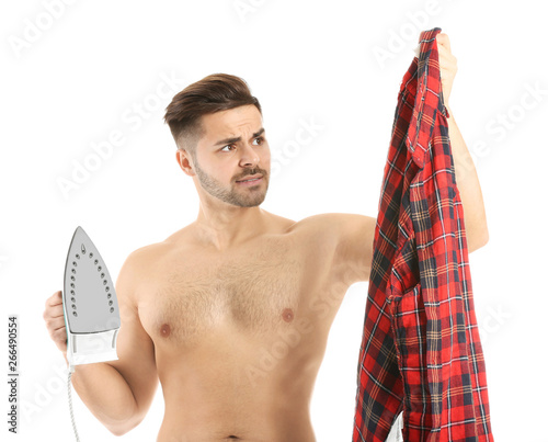 Shirtless man holding iron ...