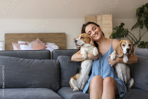 Wallpaper Mural Young woman with cute dogs sitting on sofa at home Torontodigital.ca