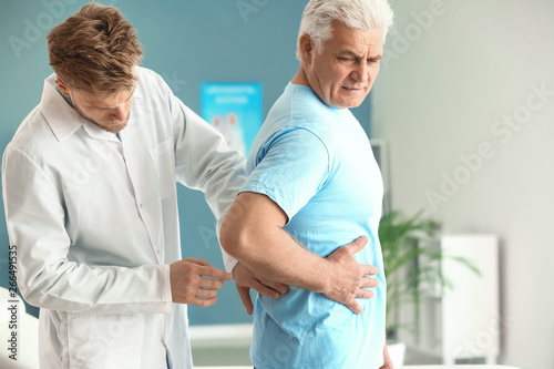 Urologist examining male pa...