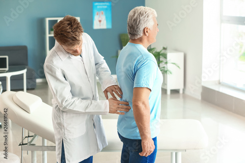 Urologist examining male pa...