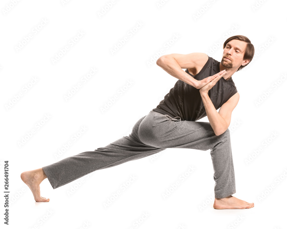 Sporty man practicing yoga on white background Sporty man practicing yoga on white background