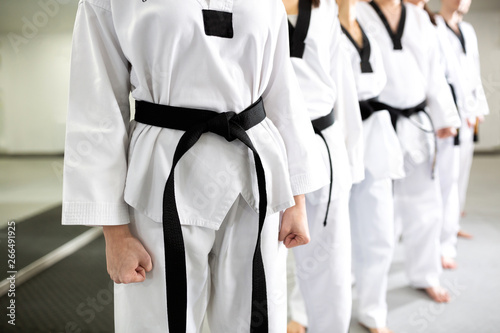 Close up of clean white martial art uniforms wearing black belts