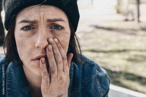 Tableau sur toile Portrait of sad homeless woman outdoors