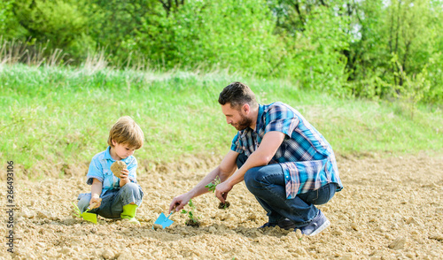 rich natural soil. Eco farm. happy earth day. Family tree. new life. soils and fertilizers. small boy child help father in farming. father and son planting flowers in ground. earth day. Garden bed