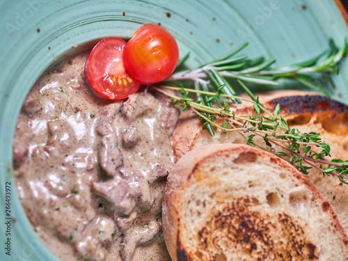 Beef stroganoff with croutons. Dark wooden background. Restaurant menu photo