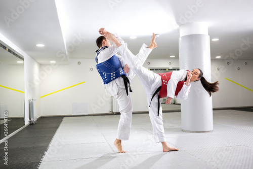 Exchange of high kicks during training of taekwondo photo
