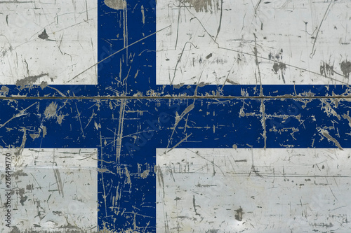 Grunge Finland flag on old scratched wooden surface. National vintage background.
